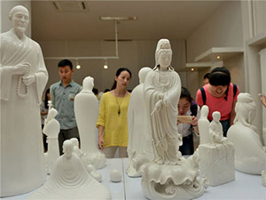 Visitors check out ceramic products made in Dehua county, Fujian province